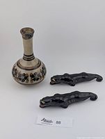 Photo of vintage ceramic vase and two ceramic black panther figurines side by side, showing overall condition and scale