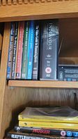 Shelf with documentary DVDs including 'Endeavour', 'The Video Guide to Illuminations' and other titles
