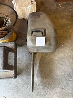 Top view of the chainsaw guide bar in the carrying case on the floor.