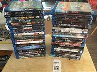 Two stacks of Blu-ray movie cases showing a total of 44 titles in good used condition.