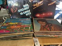 Stack of about 50 LP vinyl albums including Rod Stewart's 16 Early Hits, Bob Seger's Nine Tonight, George Jones's The Race Is On, and other assorted genres.