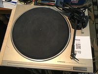 Front and top view of the Pioneer PL-8 turntable showing the platter, tonearm, power cord, and branding.