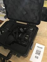 Open hard molded carrying case showing Polo Sharp Shots camera inside with lens cap and strap.