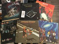 Photo showing all six rock LP vinyl albums arranged side-by-side: two Meat Loaf albums, one Supertramp, one REO Speedwagon, one Jefferson Starship, and one Earth, Wind & Fire album.