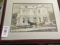 Framed print showing winter scene with horse and sleigh in front of classical building, with signature visible.