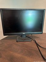 Photo of Dell D2015Hf 19.5-inch LCD monitor front view with screen and stand on table.