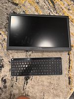 Dell D2015Hm monitor with HP keyboard placed on carpet.
