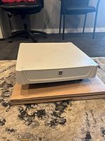 Side view of one Rittal SK 3140.110 roof-mounted fan showing square white vented housing on cardboard base.