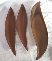 Three biomorphic wood serving bowls grouped together