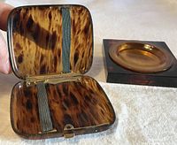 open tortoiseshell-look case beside trinket tray