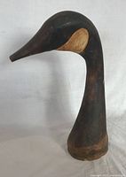 Front view of wooden loon head sculpture showing form and finish
