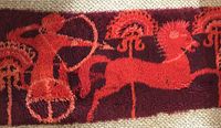 Full view of rug showing archer, horse and chariot motifs
