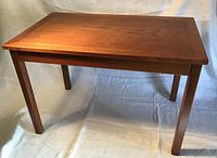 full view of rectangular teak side table on white backdrop
