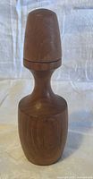 Side view of teak pepper grinder