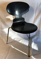 Front view of black Ant Chair showing seat, back and three-leg base