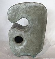 Front view of biomorphic crackle glaze vase showing circular flower opening and sculptural form