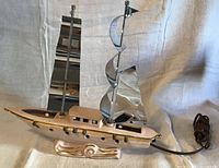 full view port side showing hull, chrome sails, cord