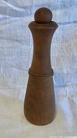 Full view of teak pepper grinder front