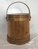 Full view of wooden firkin with lid and handle