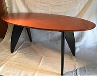 Overall view of surfboard-shape table with black legs