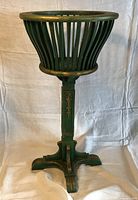 Full view of green wooden floor plant stand front