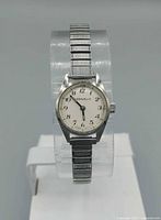 Front view of watch displaying dial, numerals, and brand name