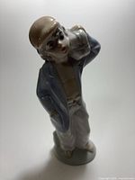 Full view of porcelain boy figurine front angle