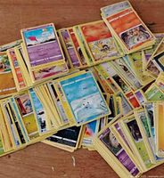 Spread of yellow-border Pokémon cards stacked and fanned out on a table