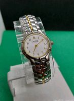 Front angled view showing dial, bezel, two-tone bracelet