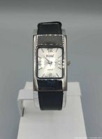 Front view showing dial, brand name, case shape and strap