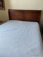 Front view showing sleigh headboard and mattress for scale