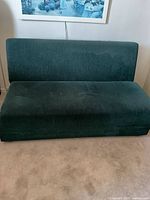 Front view of green corduroy couch in sofa position