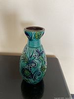 Front view of turquoise West German relief pottery vase