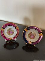 Front view of both Limoges ashtrays on stands