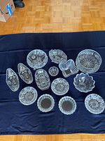 Overview of 14 crystal pieces on dark cloth