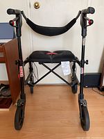 Front view of Nexus rollator walker fully opened showing seat, backrest, hand brakes and wheels