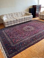 Full rug in room showing size relative to sofa
