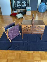 Overall view of sewing box closed beside knitting bag