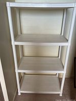 Front view of white 4-shelf plastic unit