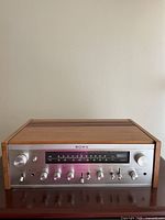 Front view showing silver face, controls and tuning dial