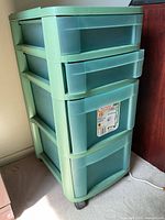 Front view of 4-drawer plastic storage tower on wheels