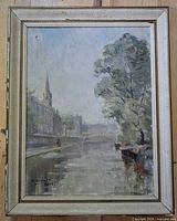 Front view of framed oil painting showing canal scene and frame