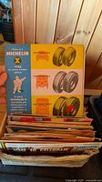 Stack of 45 RPM records in box; visible Michelin X promotional sleeve