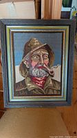 front view of framed needlepoint mariner portrait
