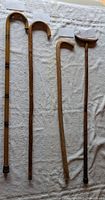 Full view of four wooden walking sticks laid out on towel