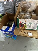 Box of Ball Quilted Crystal Jelly Jars with 12 glass jars and boxes of Ziploc bags next to it.