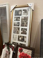 Full view of the three framed items together on a beige carpet near a vent