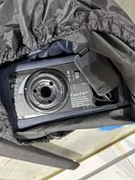 Built-in black Intex Fast-Fill electric air pump on side of blue air bed showing power switch and cord compartment.