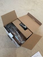 Opened box showing the clear plastic blending bottle inside, still in packaging with protective cardboard inserts.