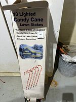 Photo of product box showing two sets of 5 lighted candy cane lawn stakes with vintage holiday decoration illustration.